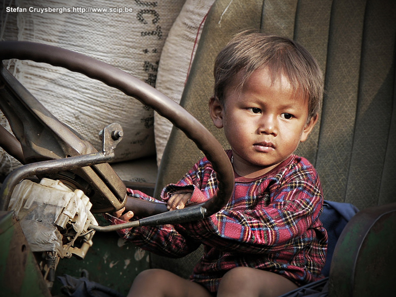 Banlung - young Cham boy A little boy on a big truck in a small Cham (Muslim) village. Stefan Cruysberghs
